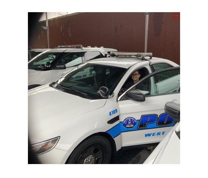 technician in a police car cleaning